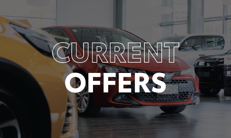 Vehicles in a showroom with overlay text that reads, "current offers"