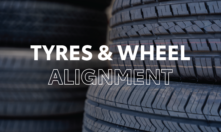 A stack of car tyres with overlay text that reads, "tyres and wheel alignment"