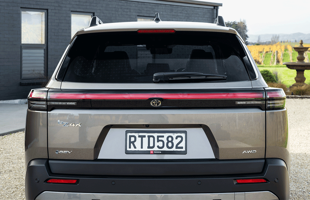 Animation of the trunk opening and closing with luggage appearing in the back of a Toyota bZ4X Touring SUV